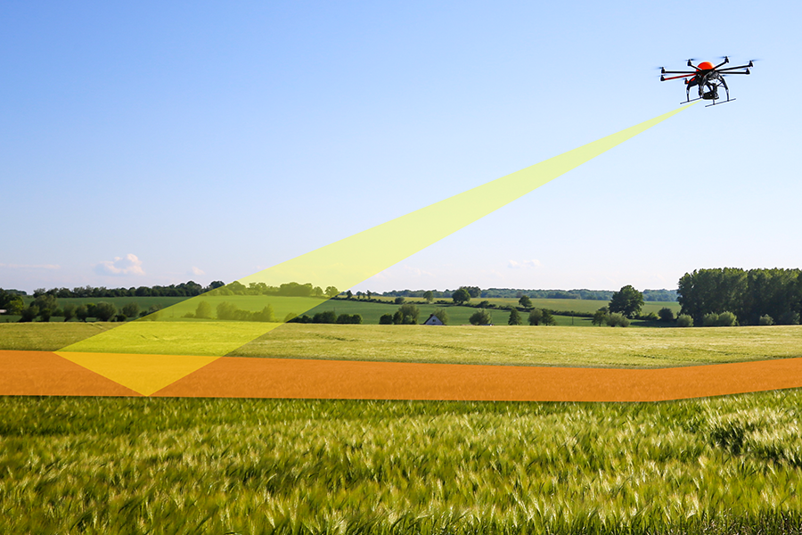 Drone following flight path over field