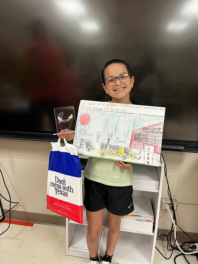 Kimbery Maria Reyes holding her award and winning submission