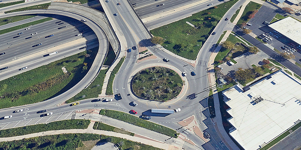 Drivers on a roundabout intersection from overhead.