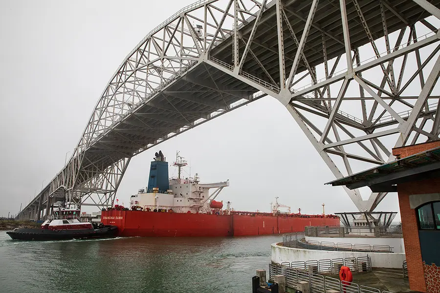 Commercial ship under bridge