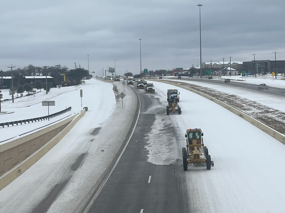 A convoy of snow plows clears I-35 in the Metroplex in January 2026. 