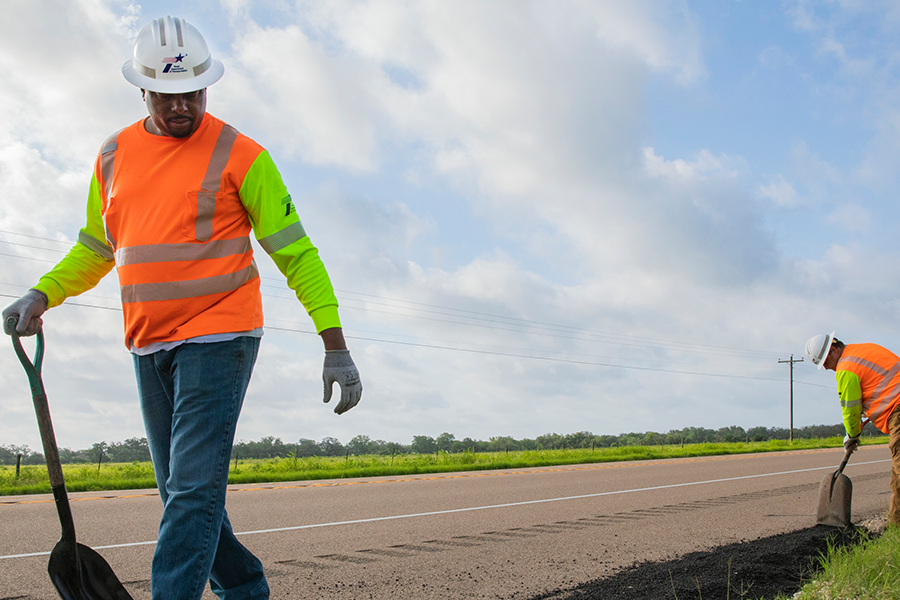 Workers repair asphalt