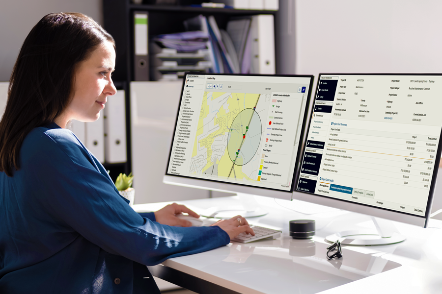 Woman in office with two monitors