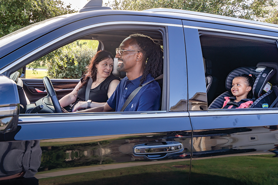 Couple driving with baby in backseat