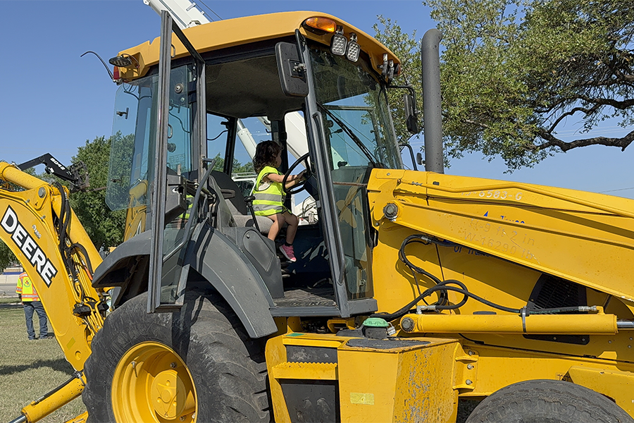 Small child behind wheel of construction vehicle