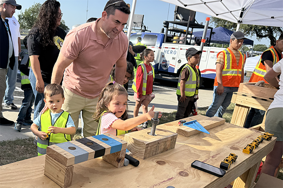 Parent with children at exhibit table