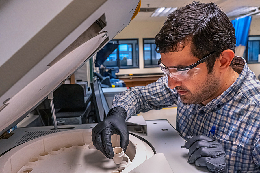 Male TxDOT employee working in the materials labs and testing samples