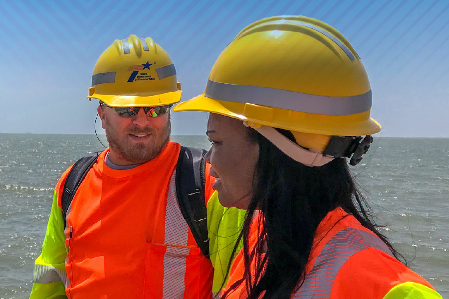 TxDOT employees wearing hardhats in the field