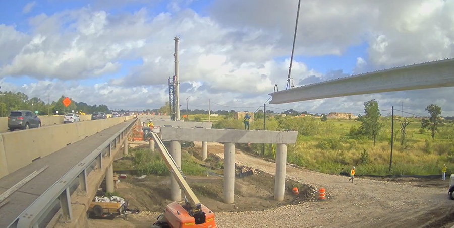 Crews install bridge beams on westbound SH 71 at Dry Creek