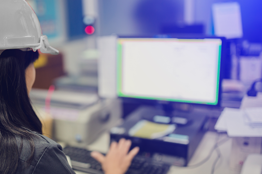 worker with hard hat at computer