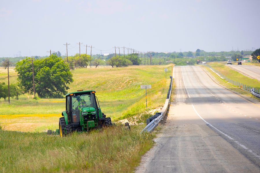 Tractor moves alongside road