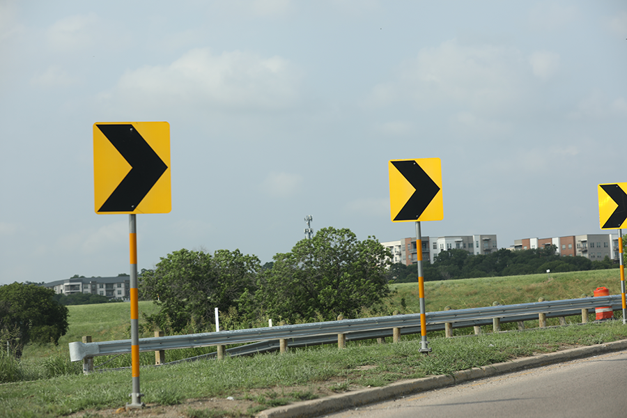 Directional signs on side of the road Directional signs on the side of the road indicating a curve in the roadway.