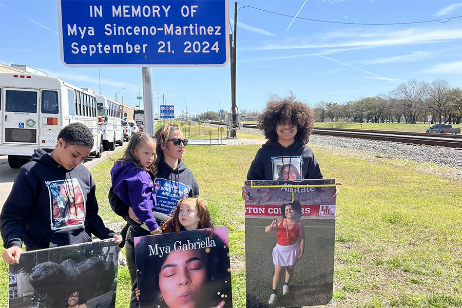 Family members next to highway memorial marker