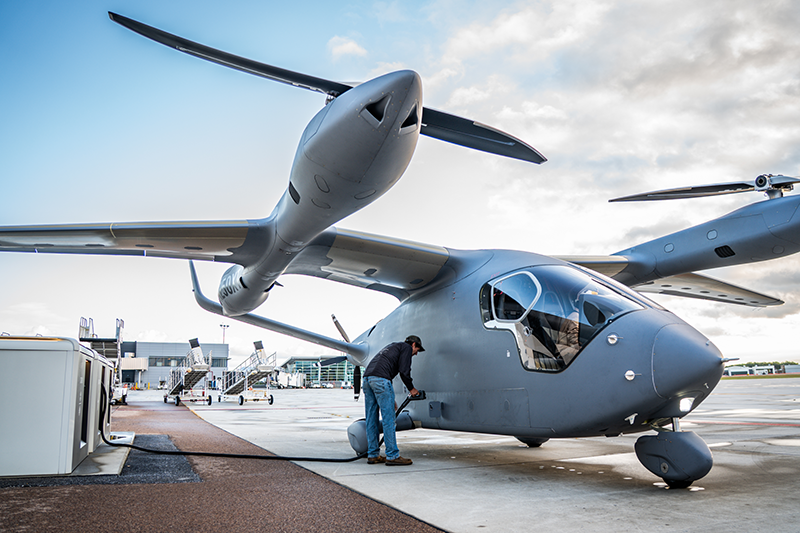 Electric Vertical Take-off and Landing (eVTOL) aircraft charging on the ground.