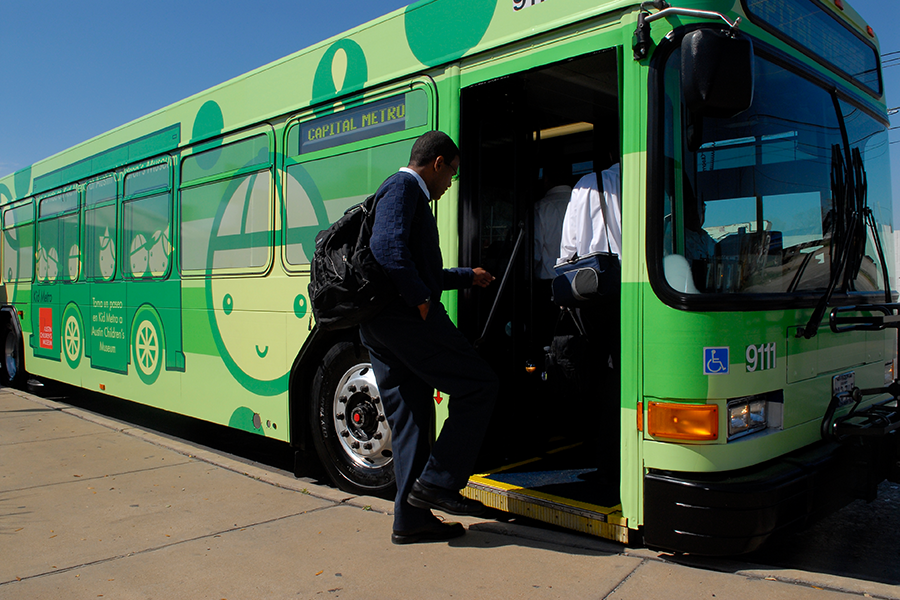 passenger boards a public bus