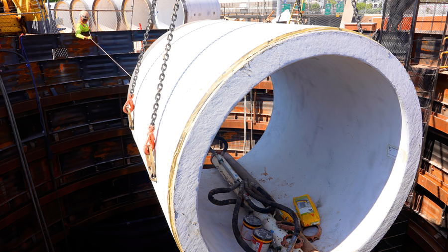 Crew members place pipe into place