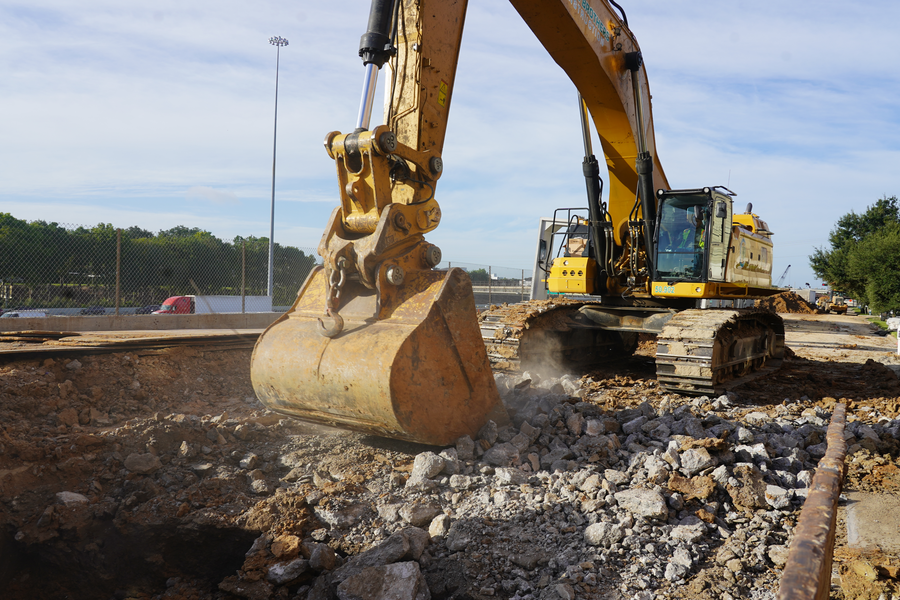 Crews remove concrete and soil from Hamilton Street near Tuam Street in preparation for storm sewer box installation