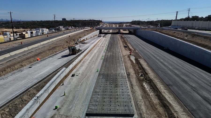 Rebar mats are installed along the future westbound US 290 mainlanes near the recently completed cross-street bridge at Scenic Brook Drive. February 2025