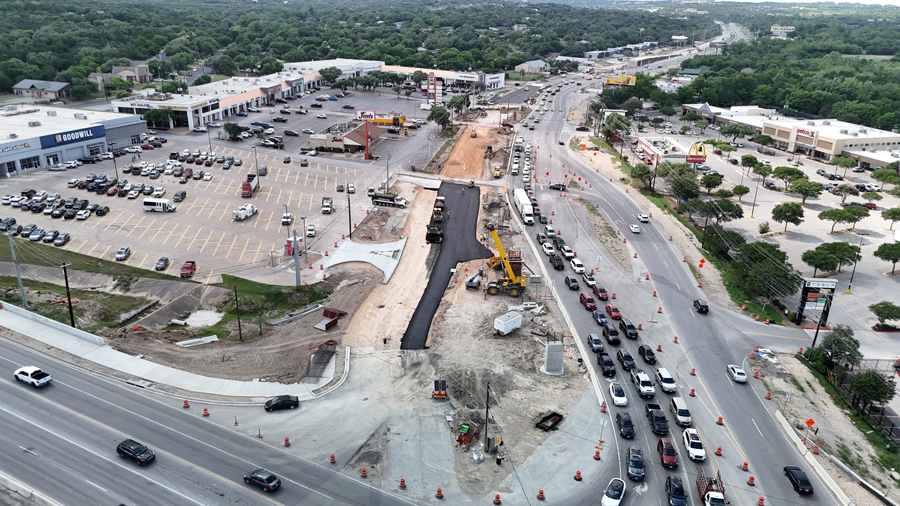 Oak Hill Parkway crews use a paver and a smooth drum static roller to place new asphalt along a portion of SH 71 near the "Y" Interchange. Once complete, these new lanes will serve as the future eastbound SH 71 frontage road.  May 2025