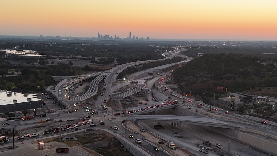 View from above the 'Y' Interchange of US 290 and SH 71 bridges under construction at sunrise, looking east. October 2025