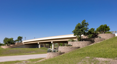 Landform modifications at interchanges can reduce the apparent scale of the structure.